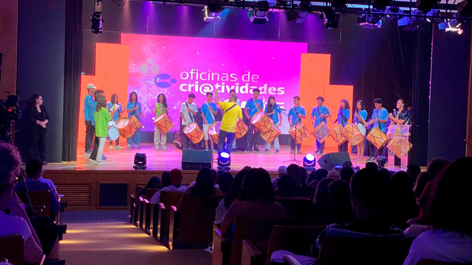 Jovens no palco se apresentando durante o evento